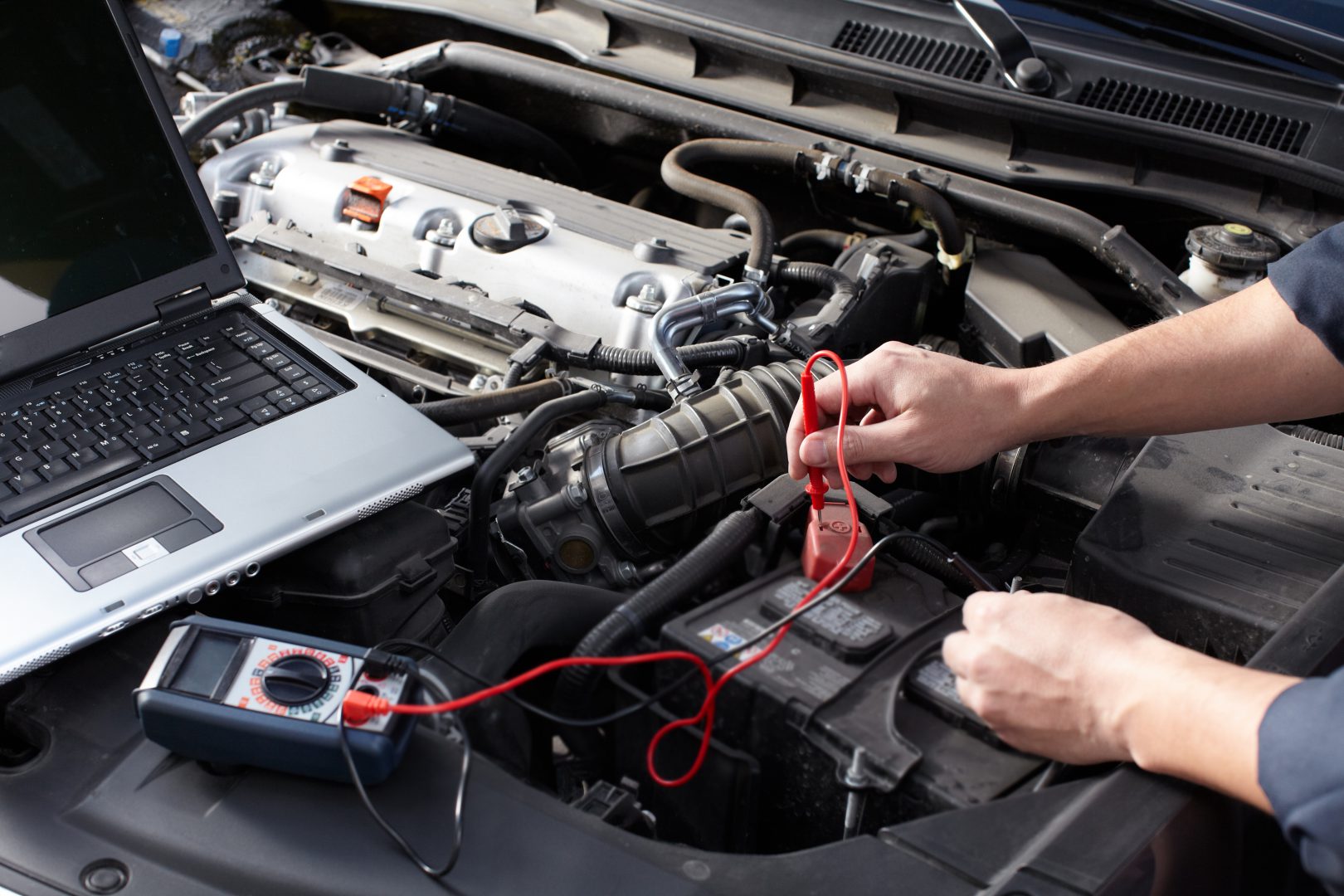 Car mechanic working in auto repair service.