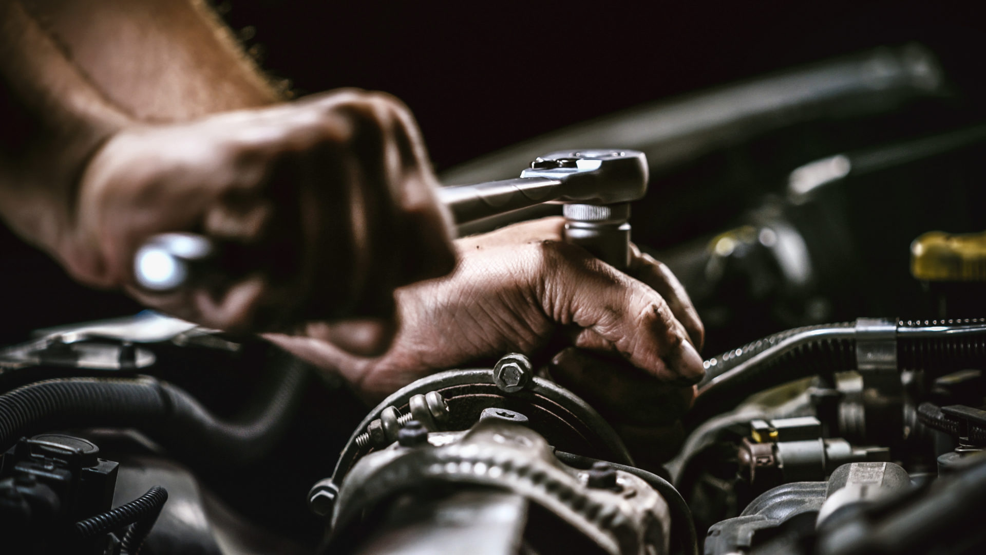 Auto mechanic working on car engine in mechanics garage. Repair